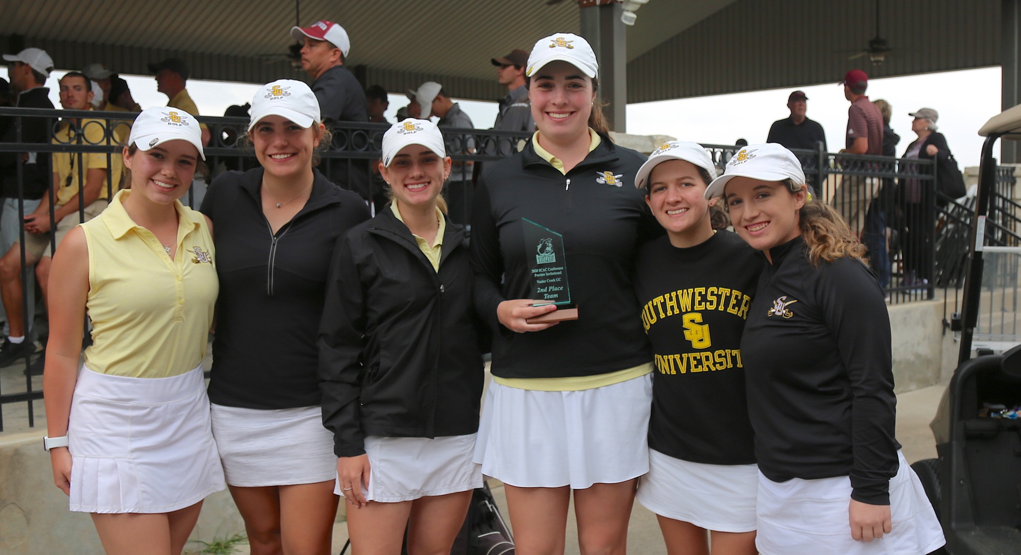 The Southwestern University Pirates golf team poses with their second-place trophy. 