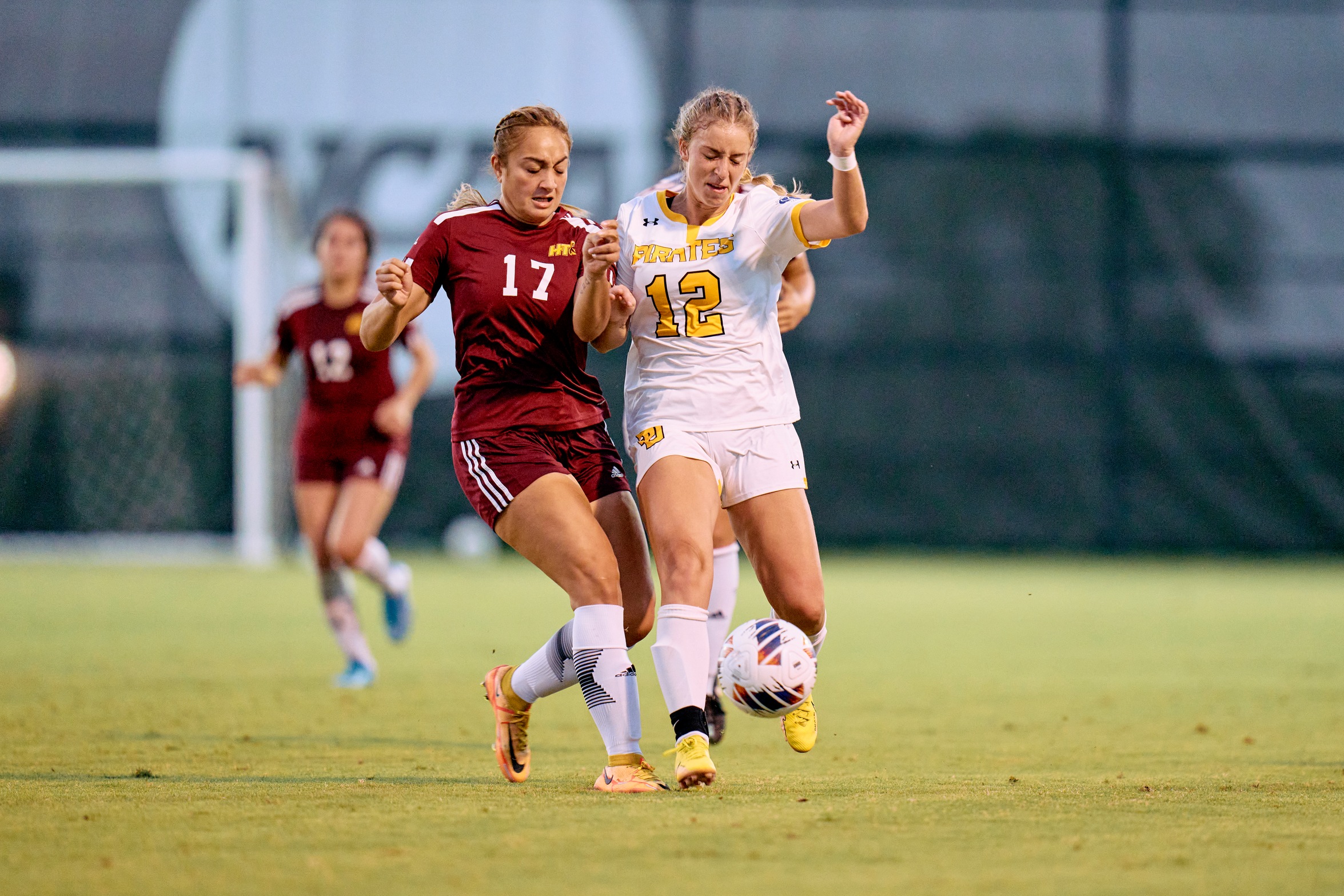Samantha Hazen (12) battles for possession against a Huston-Tillotson defender earlier this season. Hazen tallied a goal and an assist against Schreiner on Sunday. (Photo courtesy of Carlos Barron)