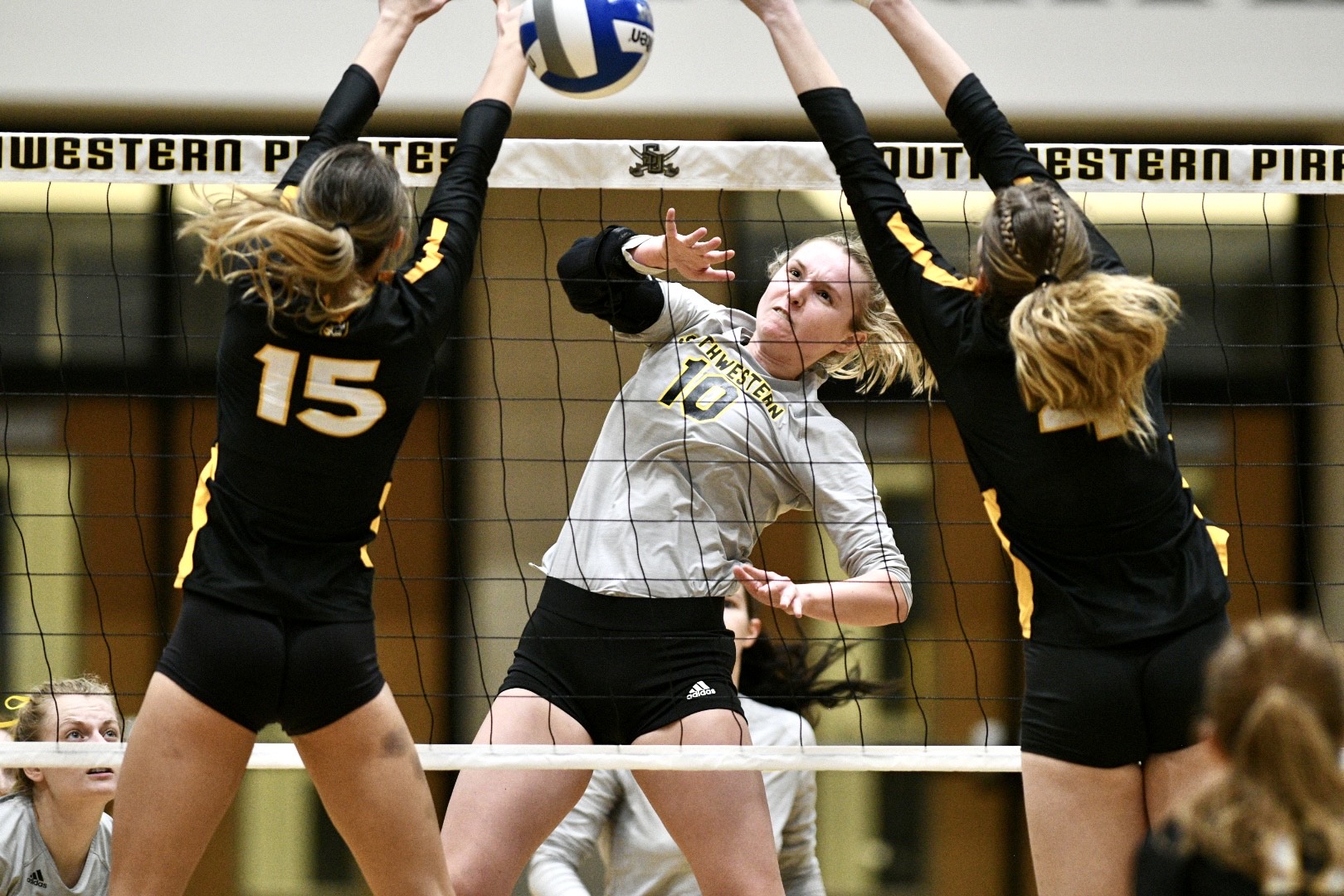 Riley Brantley tries to get an attack past two Colorado College blockers at the net. 
